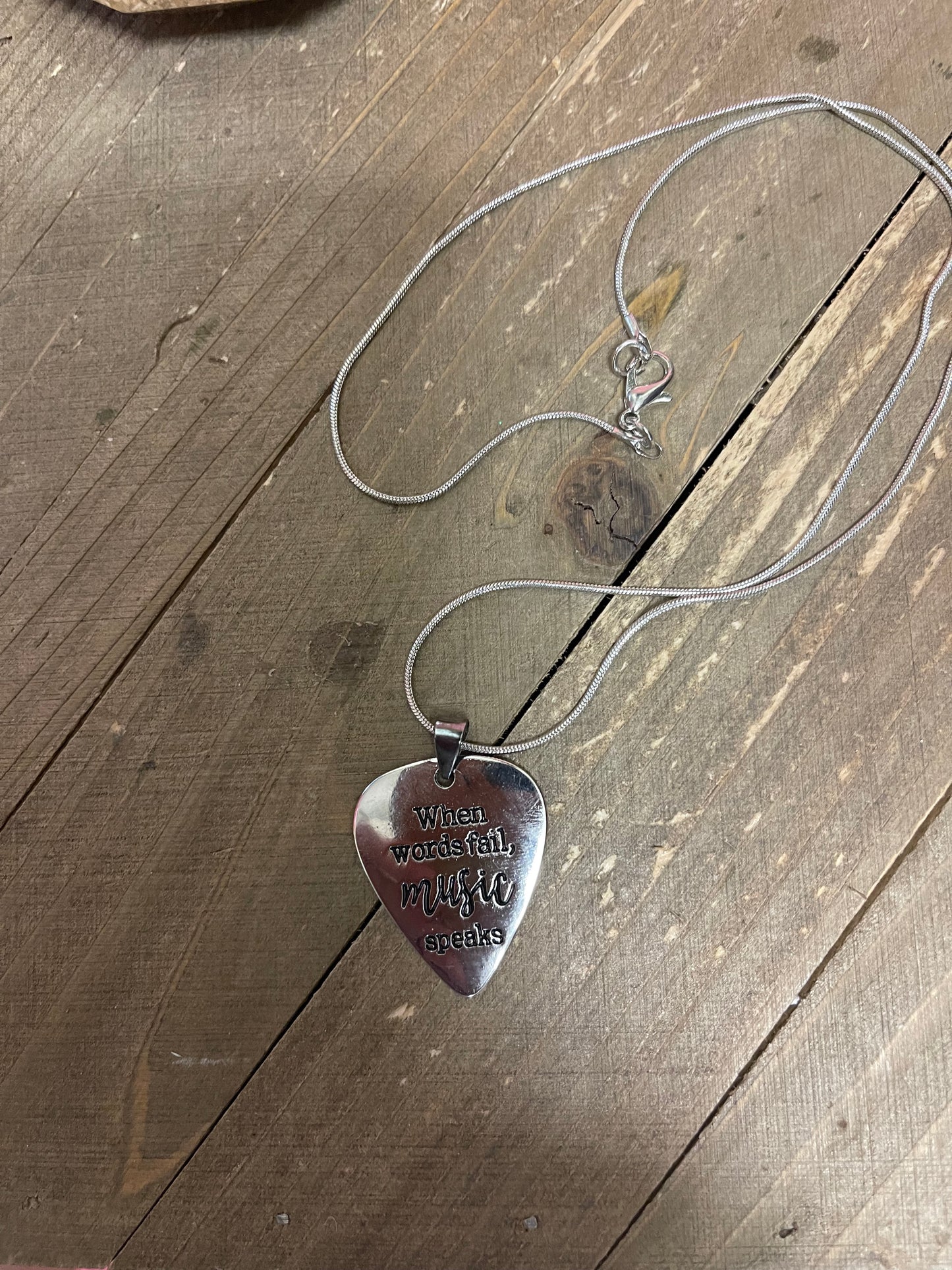 Music Speaks Guitar Pick Pendant on a Silver chain Necklace