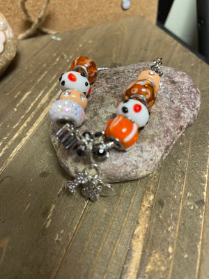 Orange, White & Plush Glass Mix and Mingle beads with a dog Charms on a silver bracelet